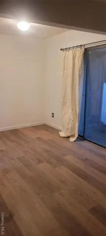 a view of a closet with wooden floor