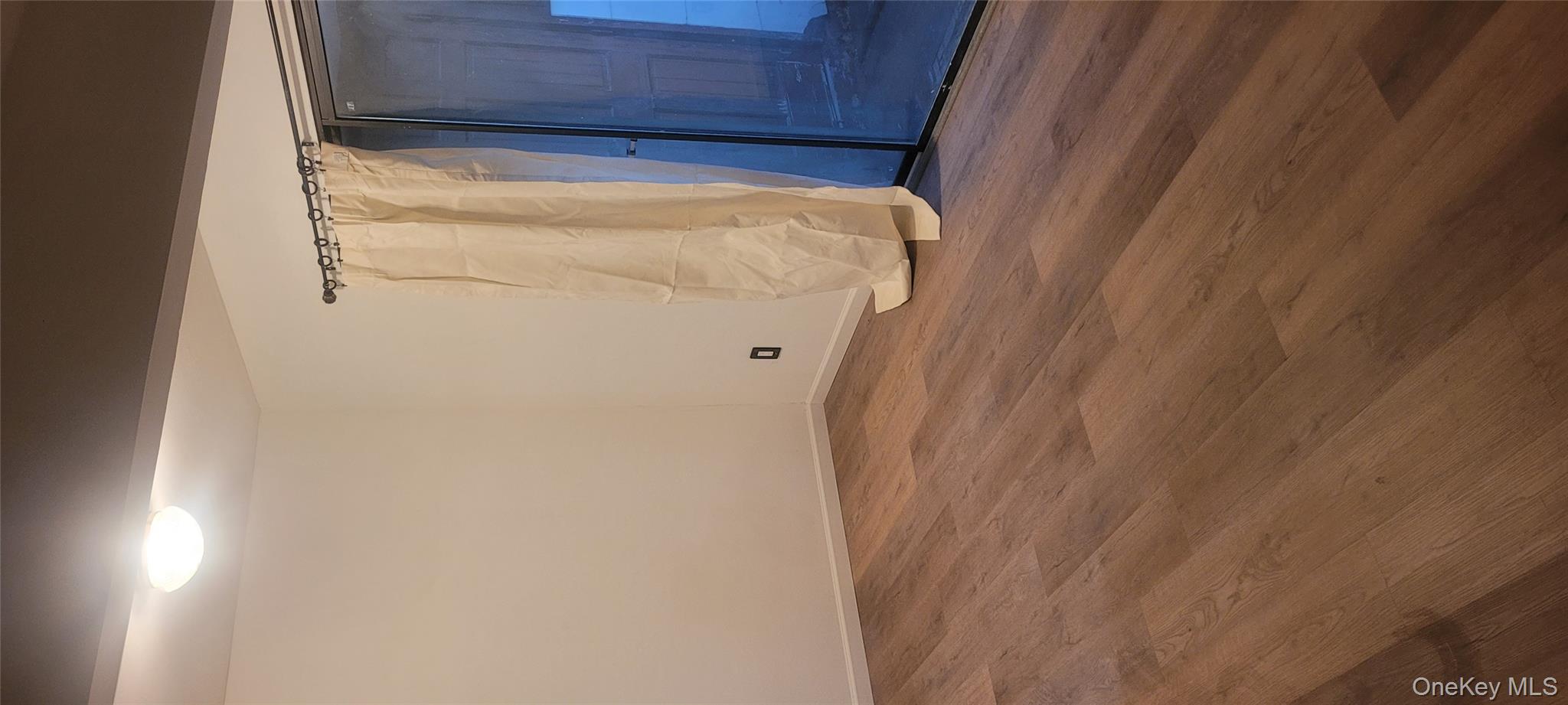2 Williamsburg Court, Unit C Ridge, NY 11961 - Photo 12 of 20 Spare room featuring baseboards and dark wood-style flooring