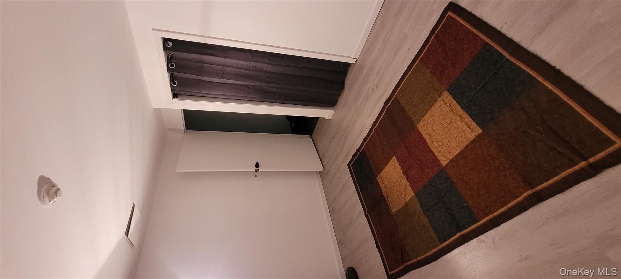 2 Williamsburg Court, Unit C Ridge, NY 11961 - Photo 14 of 20 Empty room featuring wood finished floors