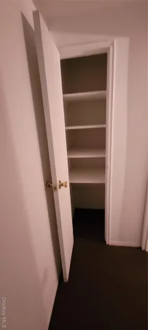 a view of an empty room with windows