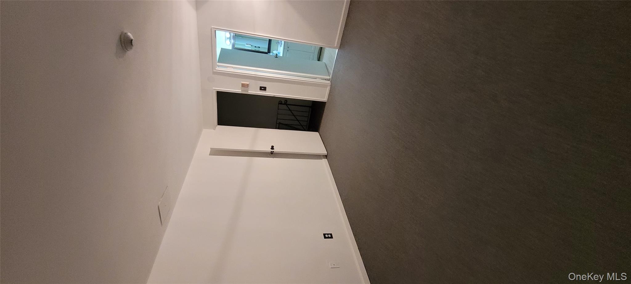 2 Williamsburg Court, Unit C Ridge, NY 11961 - Photo 20 of 20 Empty room with dark colored carpet and baseboards