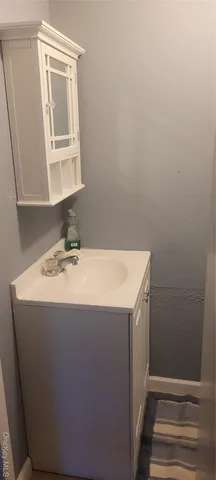 a utility room with a sink a mirror and vanity