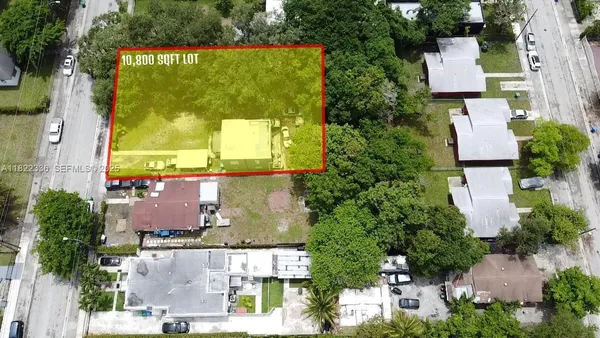 an aerial view of residential houses with outdoor space and street view