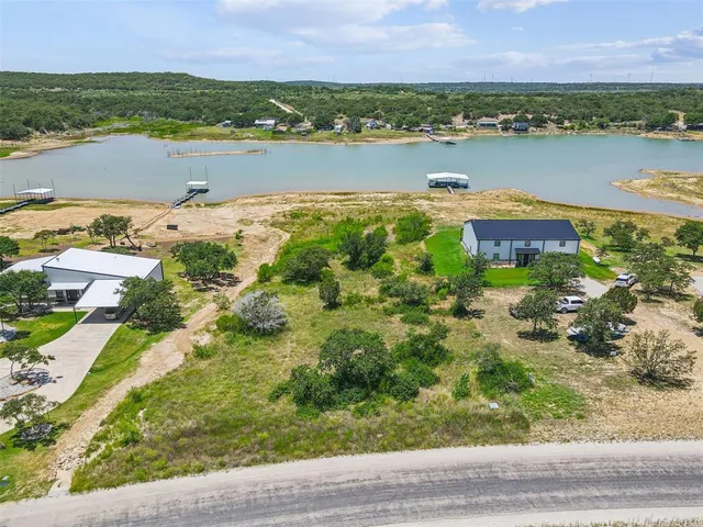 an aerial view of a house with a lake view