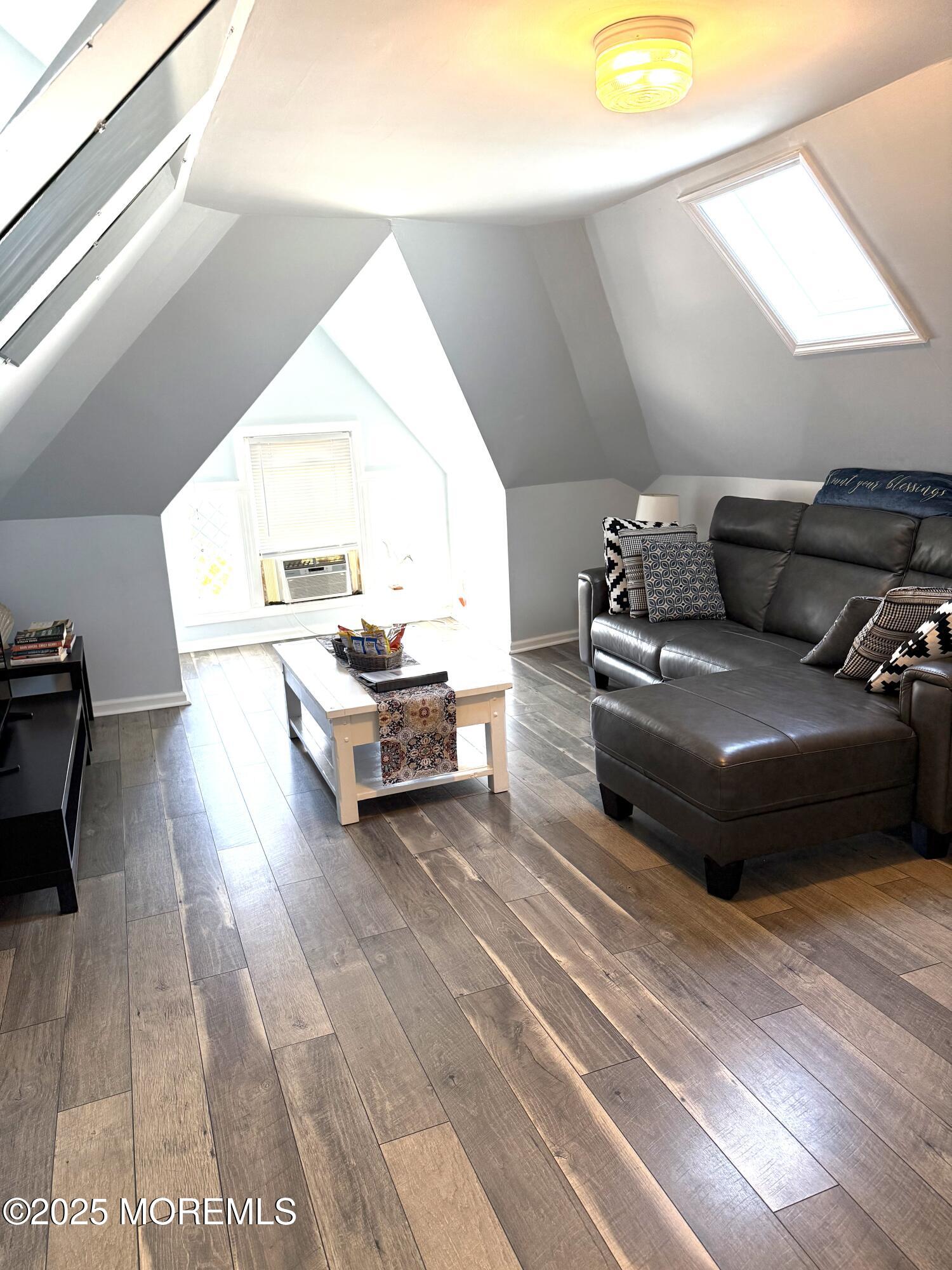 401 2nd Avenue Asbury Park, NJ 07712 - Photo 5 of 13 a living room with furniture and a wooden floor