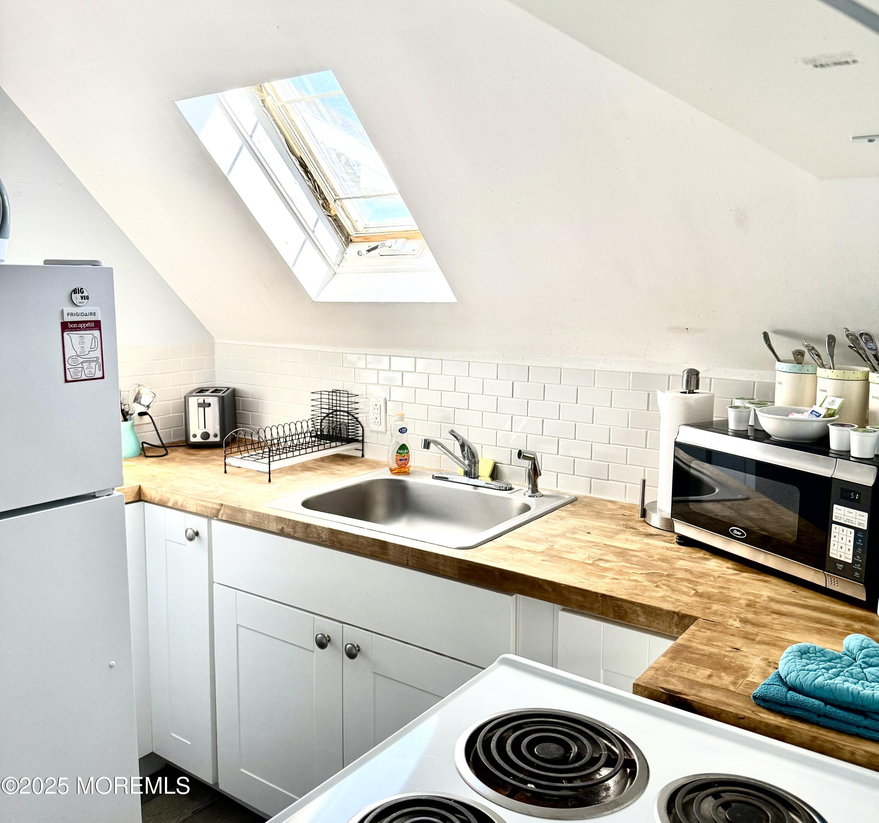 401 2nd Avenue Asbury Park, NJ 07712 - Photo 8 of 13 a kitchen with a sink and a stove top oven