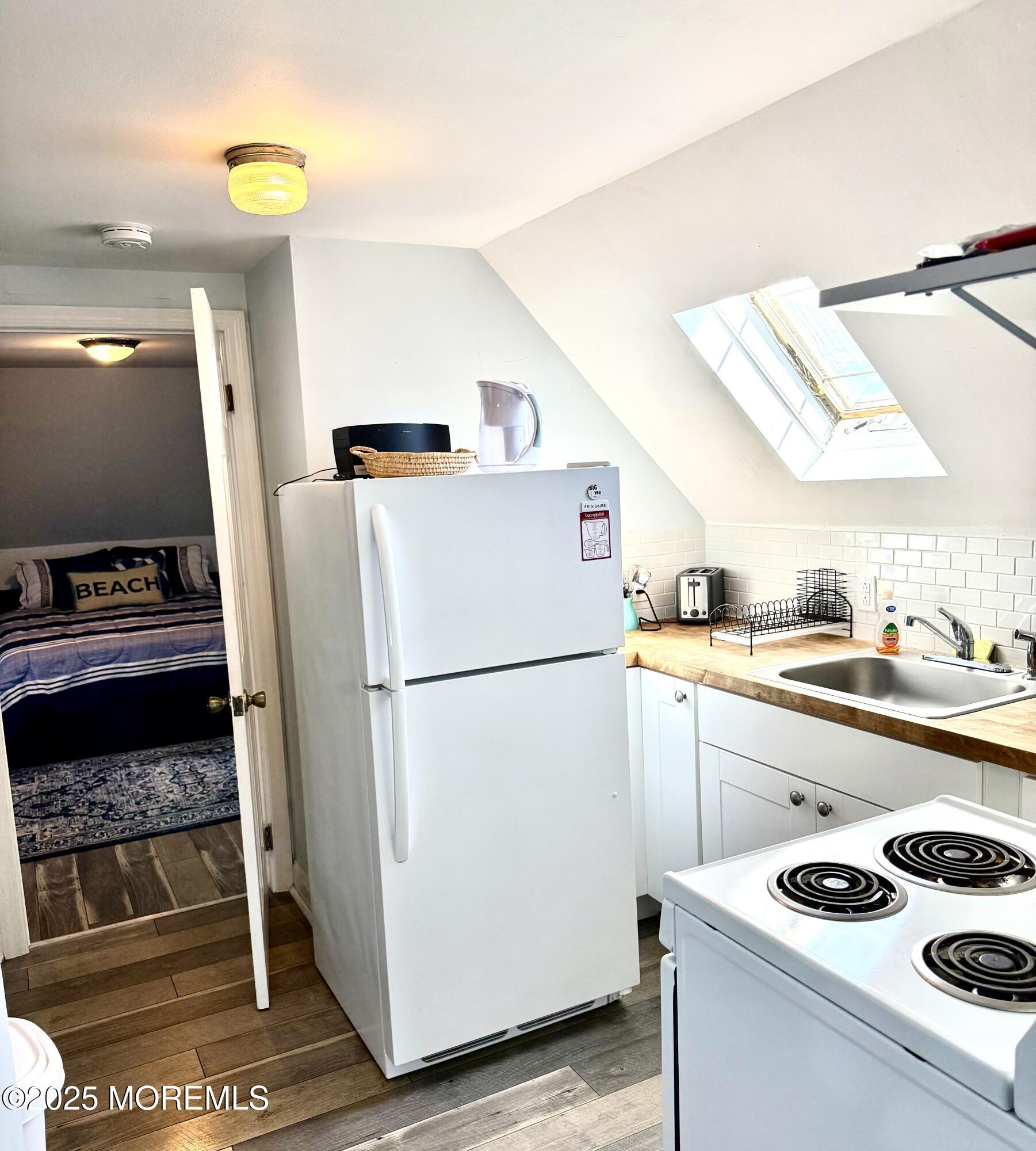 401 2nd Avenue Asbury Park, NJ 07712 - Photo 9 of 13 a white refrigerator freezer and a stove sitting inside of a kitchen