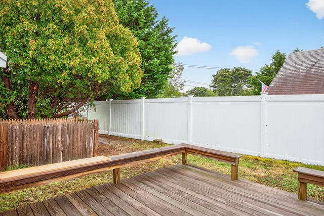 a wooden bench sitting in front of a house
