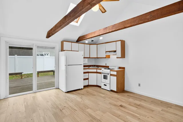 a kitchen with a refrigerator and a stove top oven