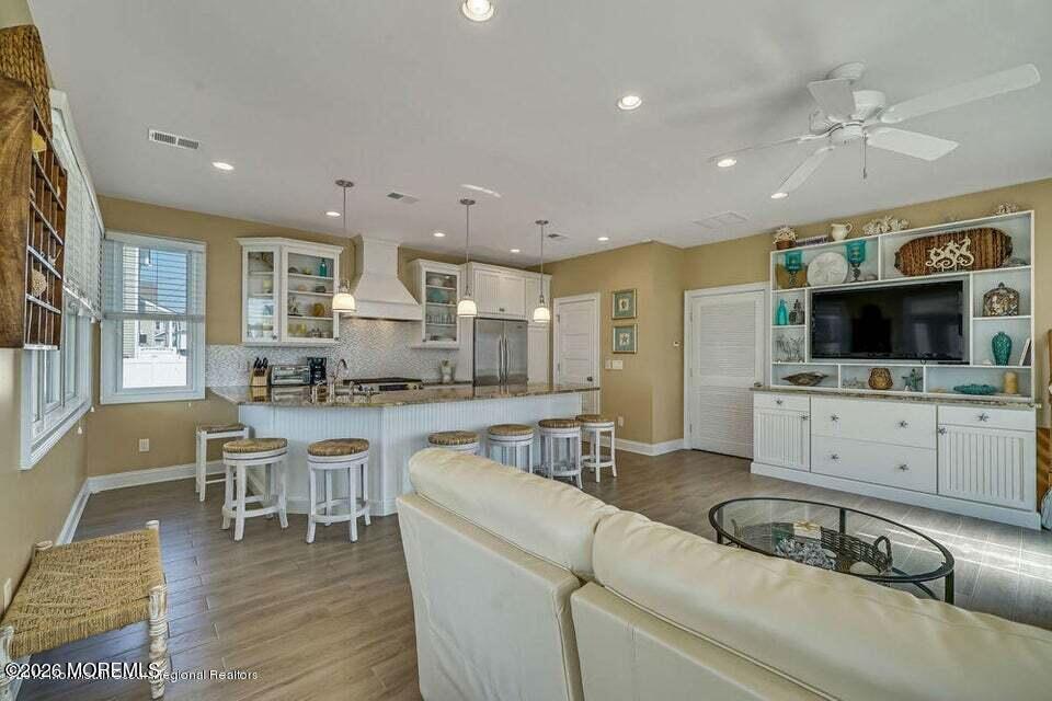10 4th Avenue, Unit 101 Seaside Heights, NJ 08751 - Photo 9 of 20 a living room with furniture and flat screen tv