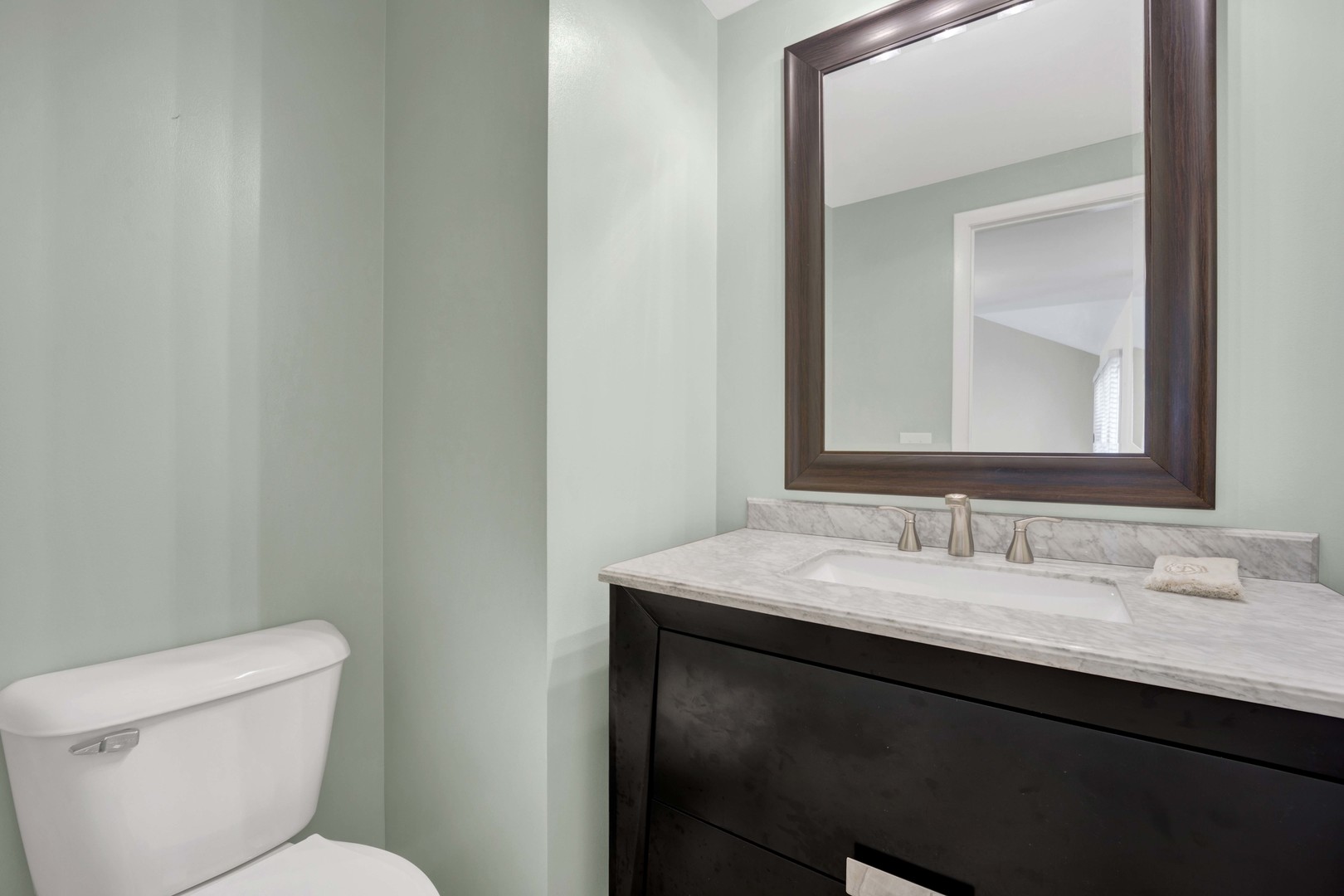 2631 Smith Street Rolling Meadows, IL 60008 - Photo 11 of 24 a bathroom with a toilet sink and mirror
