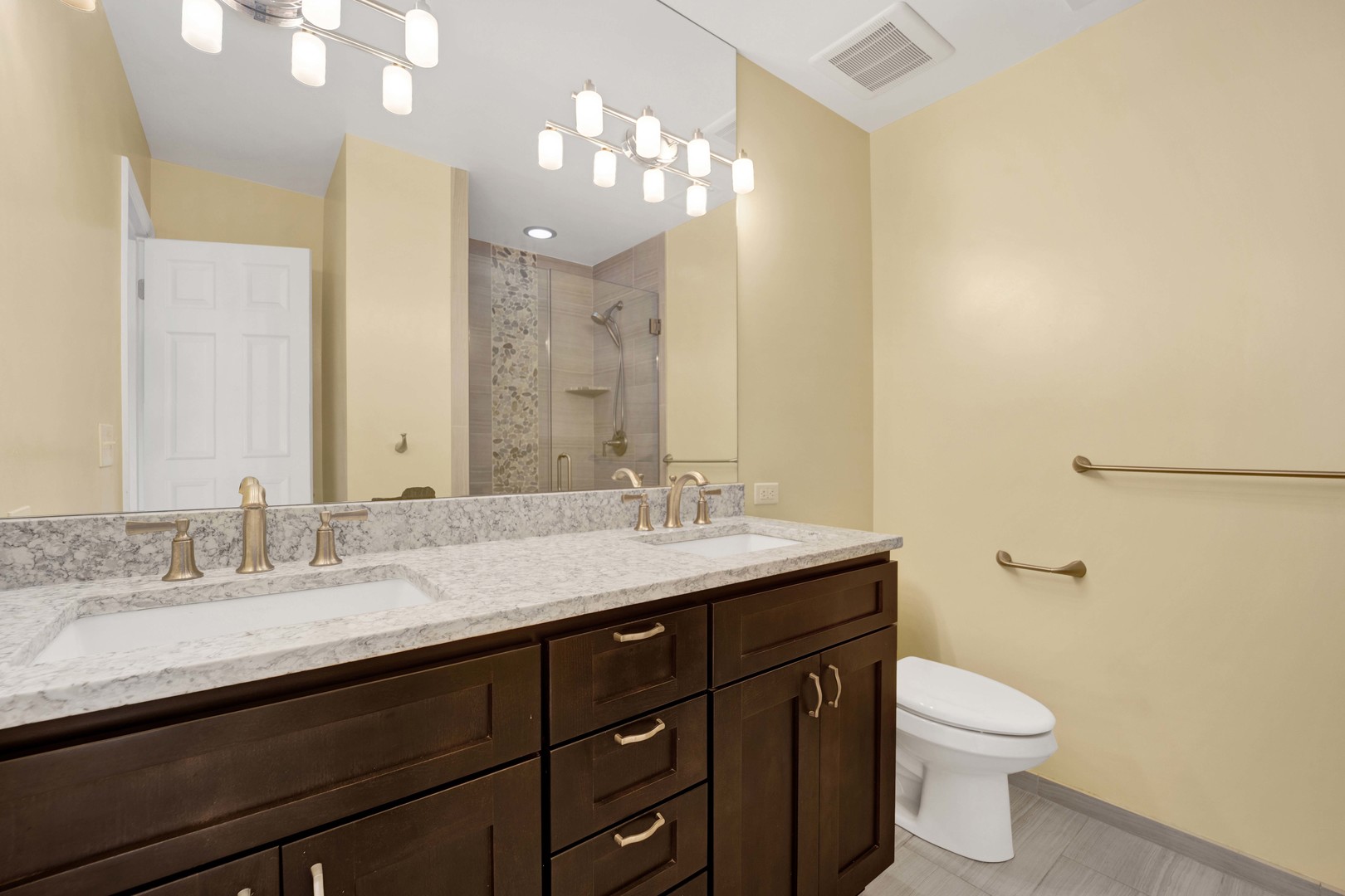 2631 Smith Street Rolling Meadows, IL 60008 - Photo 14 of 24 a bathroom with a granite countertop sink a toilet and a mirror