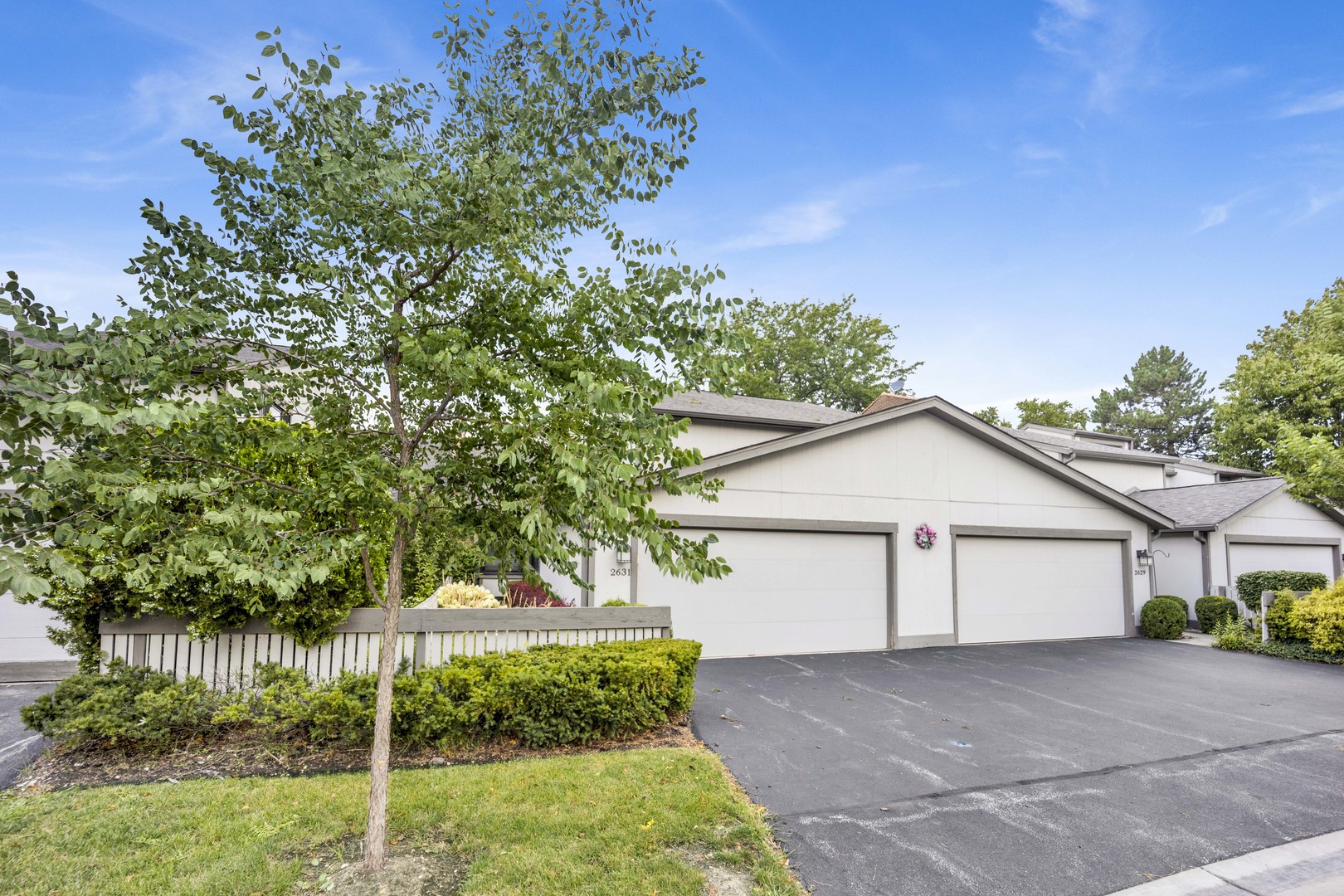 2631 Smith Street Rolling Meadows, IL 60008 - Photo 2 of 24 a front view of a house with a yard and garage