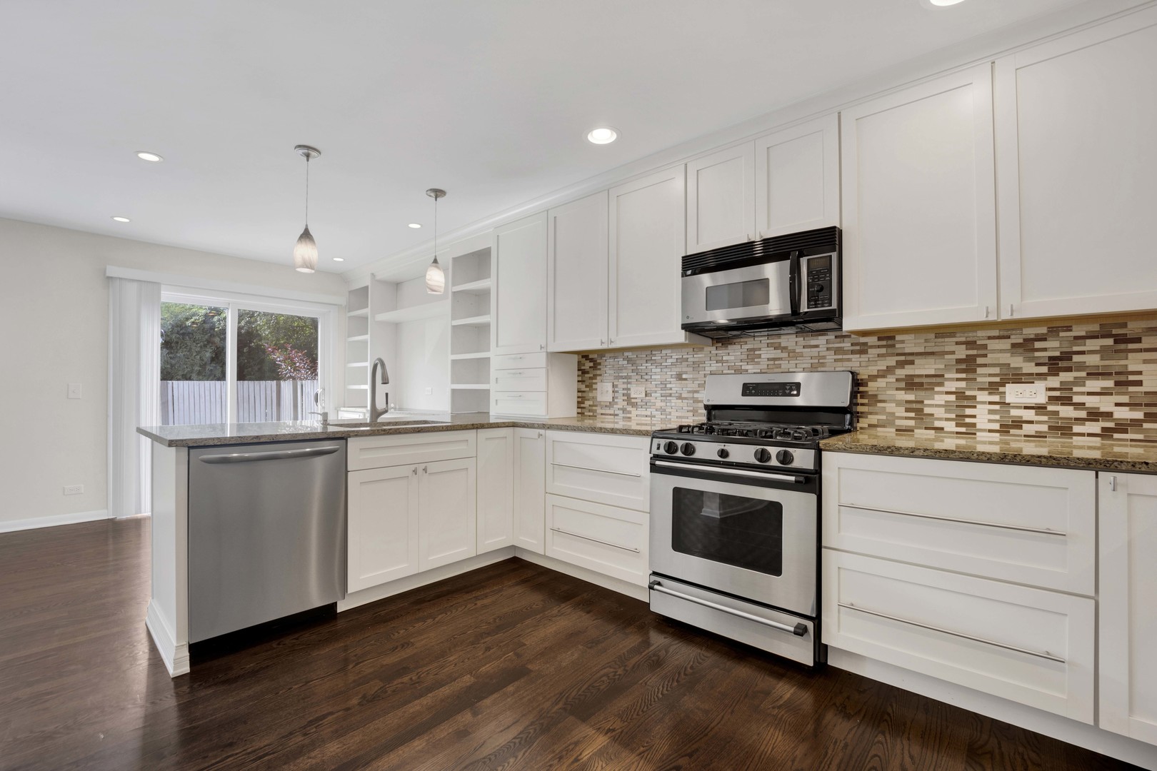 2631 Smith Street Rolling Meadows, IL 60008 - Photo 8 of 24 a kitchen with stainless steel appliances granite countertop a stove a sink and a microwave