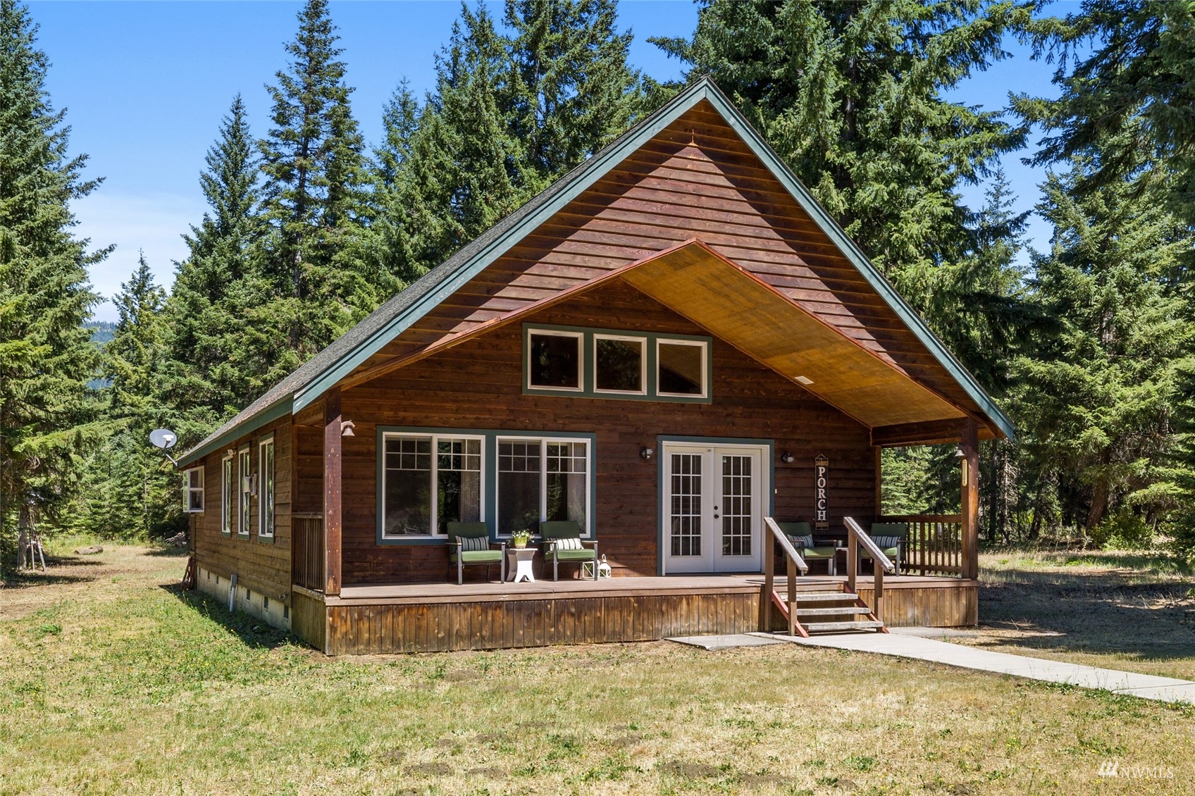 5711 Nelson Siding Road Cle Elum, WA 98922 - Photo 2 of 40 a front view of a house with a yard table and chairs