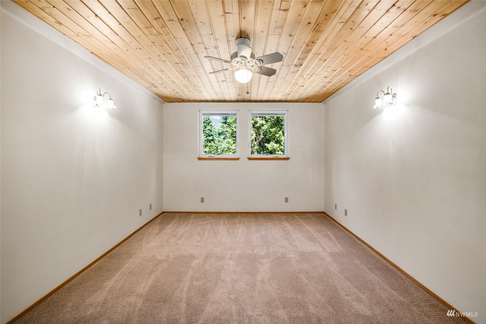 5711 Nelson Siding Road Cle Elum, WA 98922 - Photo 35 of 40 an empty room with a chandelier fan and windows