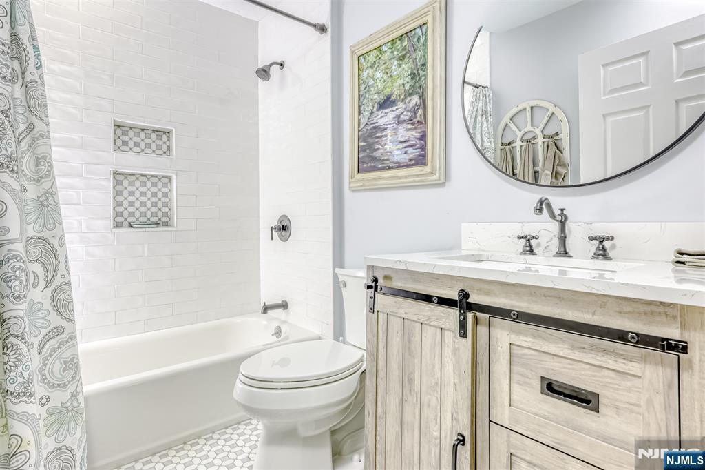 667 Juniper Way, Unit 667 Mahwah, NJ 07430 - Photo 13 of 14 a bathroom with a sink a toilet and a mirror