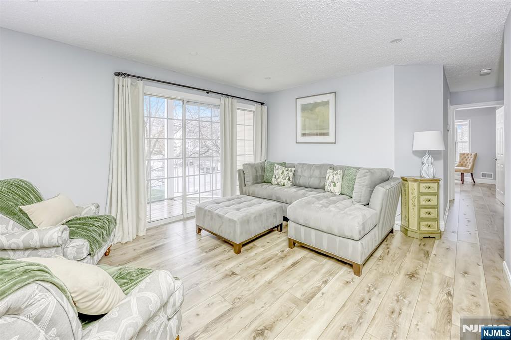 667 Juniper Way, Unit 667 Mahwah, NJ 07430 - Photo 3 of 14 a living room with furniture and a large window
