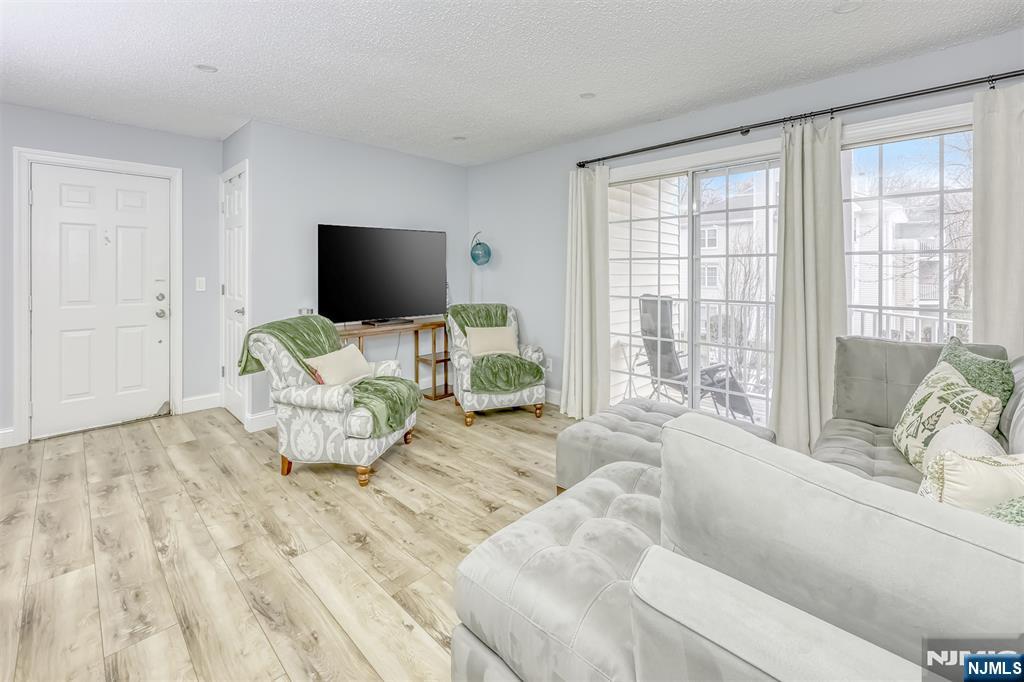 667 Juniper Way, Unit 667 Mahwah, NJ 07430 - Photo 4 of 14 a living room with furniture and a flat screen tv