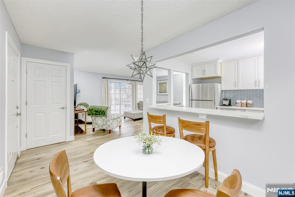 667 Juniper Way, Unit 667 Mahwah, NJ 07430 - Photo 8 of 14 a dining room with furniture a chandelier and window