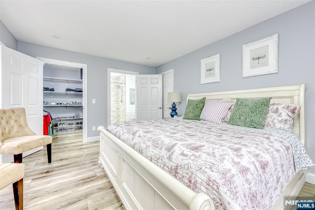 667 Juniper Way, Unit 667 Mahwah, NJ 07430 - Photo 10 of 14 a spacious bedroom with a bed and glass window