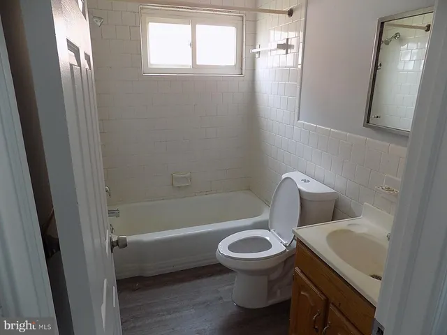 a white toilet sitting next to a bathroom sink