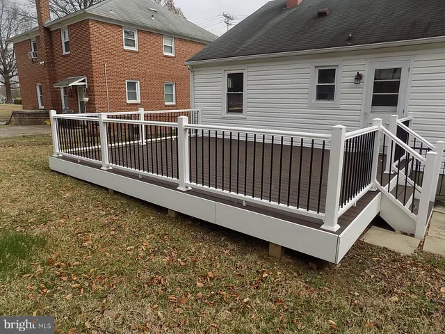 a view of a house with a wooden deck