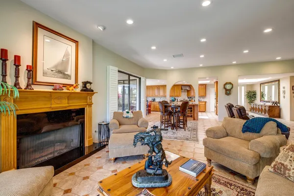 a living room with furniture large window and fireplace
