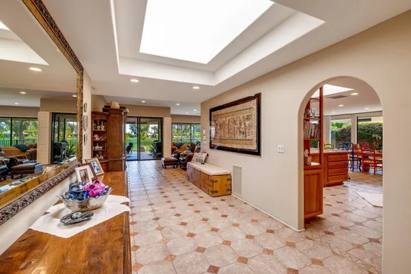a living room with fireplace furniture and a large window