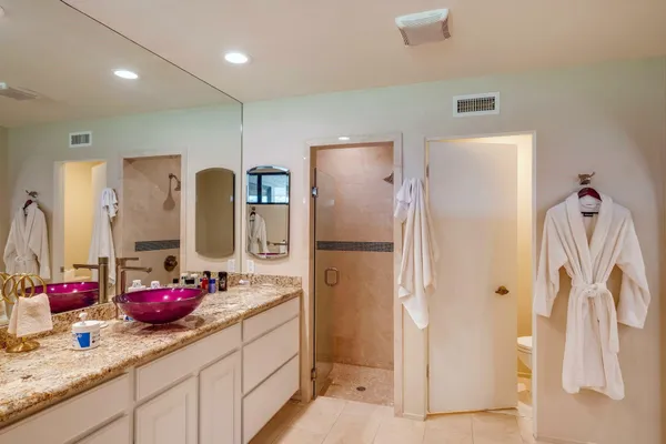 a bathroom with a sink double vanity and a shower