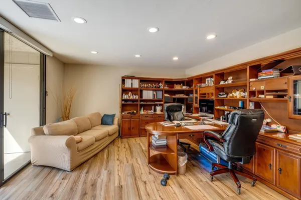 a living room with furniture and a book shelf