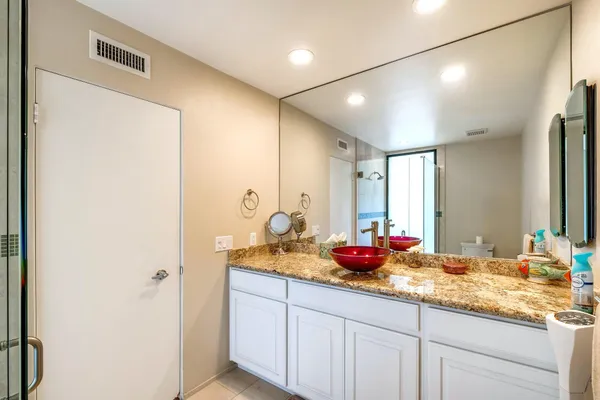 a bathroom with a double vanity sink and a mirror