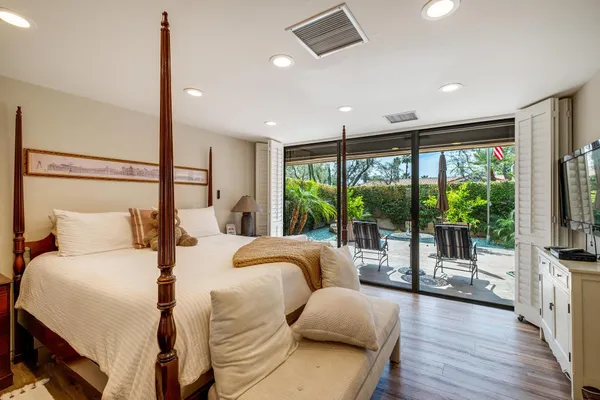 a bedroom with a bed and a large window