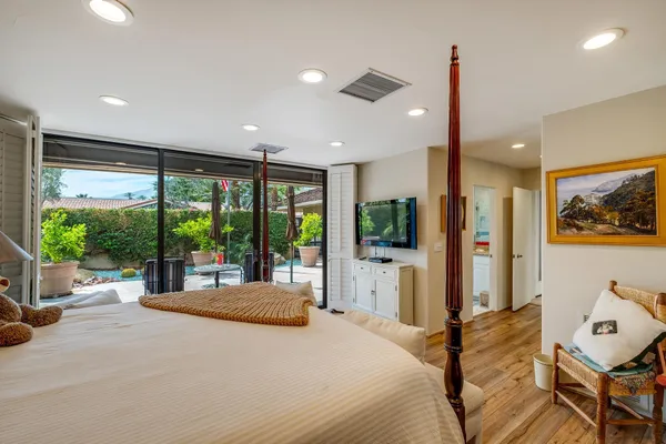 a bedroom with a large bed and a large window