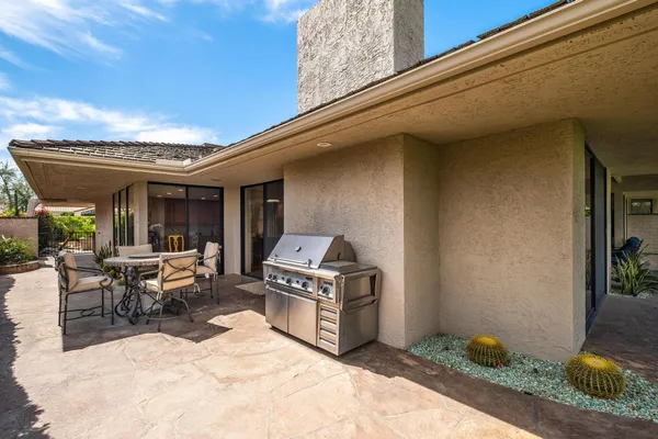 a view of a patio with table and chairs and potted plants