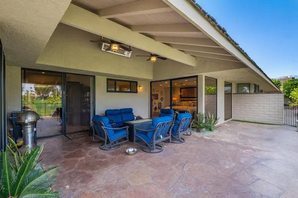 a view of a patio with table and chairs and potted plants