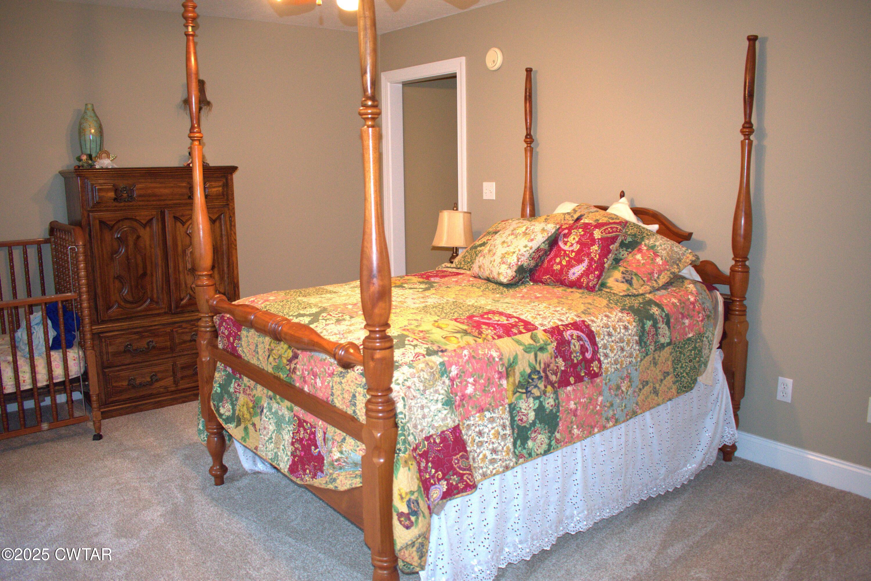 715 Roundtree Lane Beech Bluff, TN 38313 - Photo 17 of 24 a bedroom with bed and wooden floor