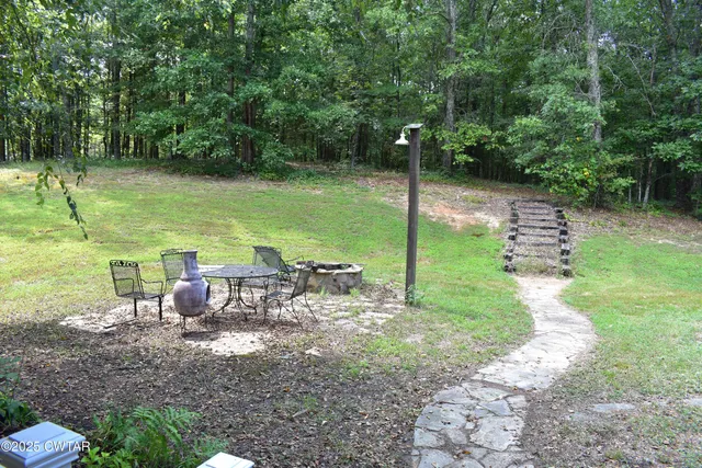 a view of a garden with lawn chairs