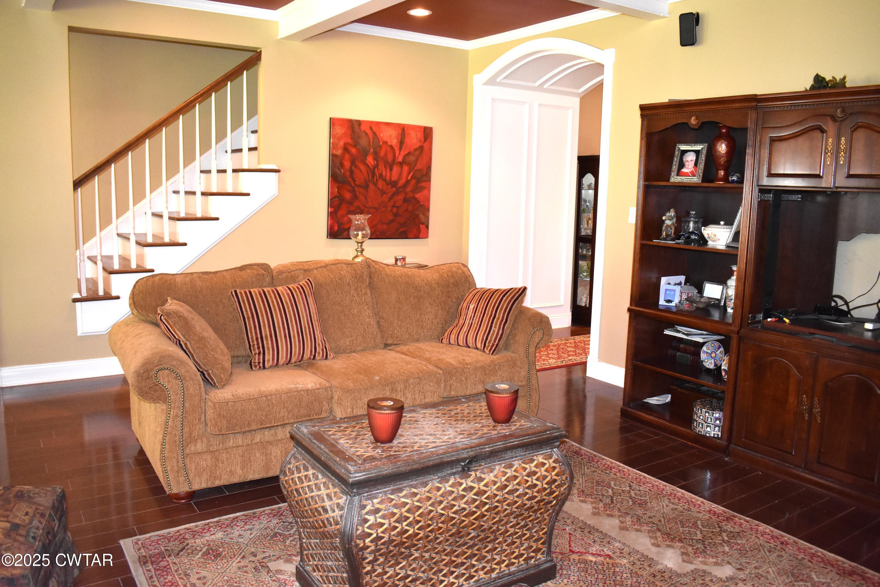 715 Roundtree Lane Beech Bluff, TN 38313 - Photo 9 of 24 a living room with furniture a rug and a book shelf