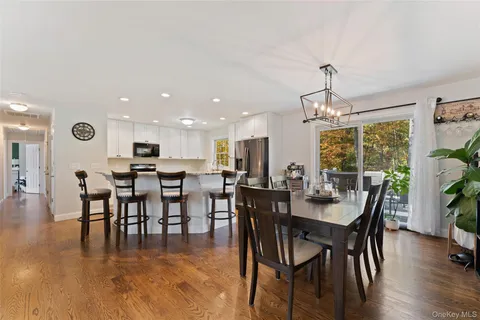a dining room with furniture window and wooden floor