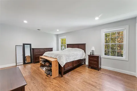 a bedroom with a bed lamp closet and window