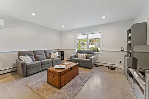 a living room with furniture window and a flat screen tv