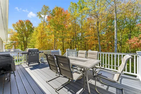 a view of a balcony with furniture and wooden floor