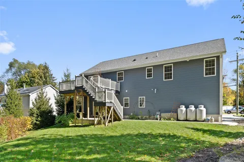 a house view with a sitting space and garden