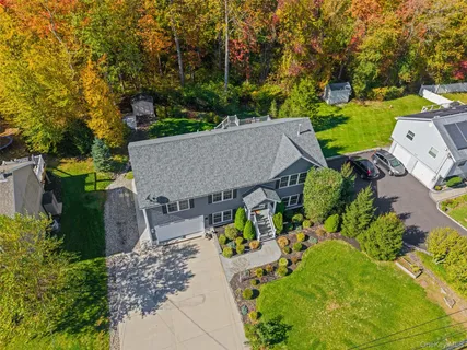 an aerial view of a house with garden space and street view