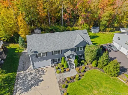 an aerial view of a house with swimming pool garden and patio