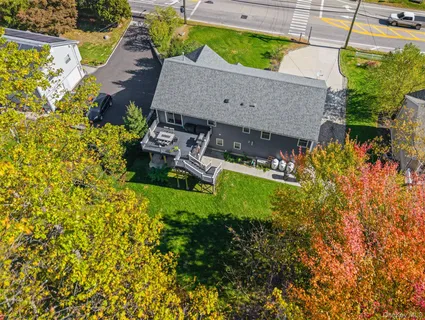 an aerial view of a house with garden space and street view
