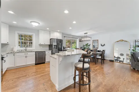 a living room with furniture a dining table and kitchen view