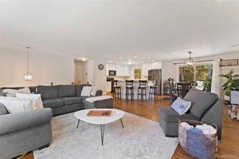 a living room with furniture kitchen and a table