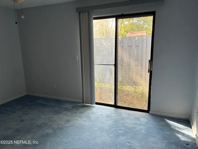 a room view with a ceiling fan